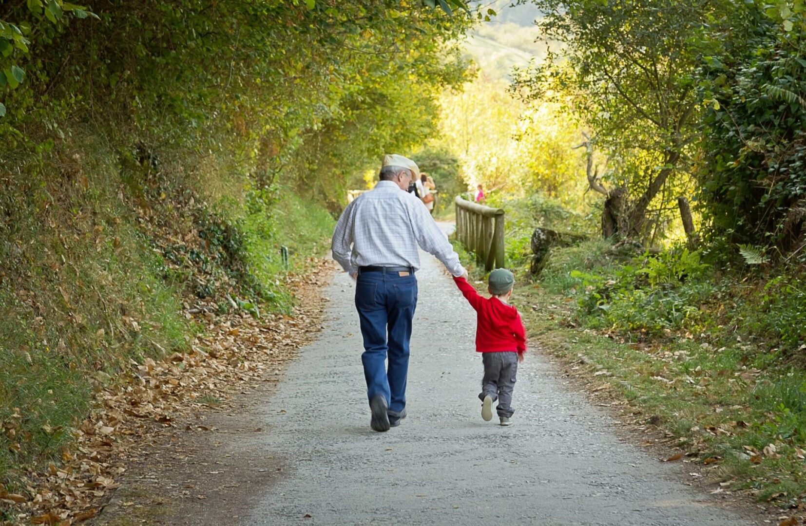 A man and child walking down the road